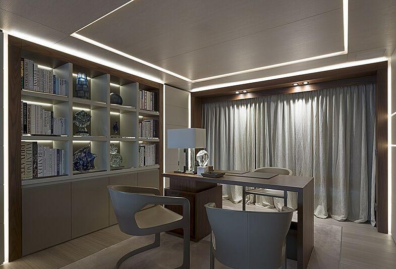 a room with a bookcase and a desk aboard UTOPIA IV Yacht for Charter