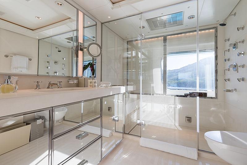 a bathroom with a large glass shower aboard FLAG Yacht for Charter