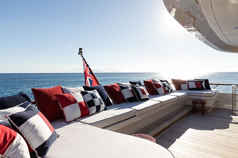 a large bed with a flag on it aboard FLAG Yacht for Charter