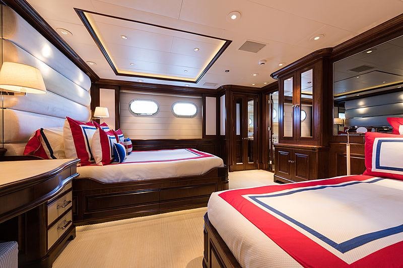 a room with double beds aboard FLAG Yacht for Charter