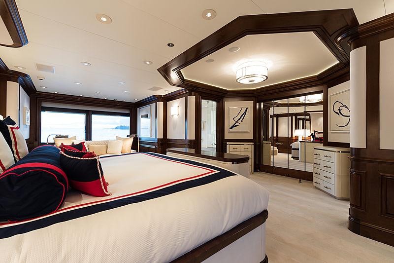 a large bedroom with a large bed aboard FLAG Yacht for Charter
