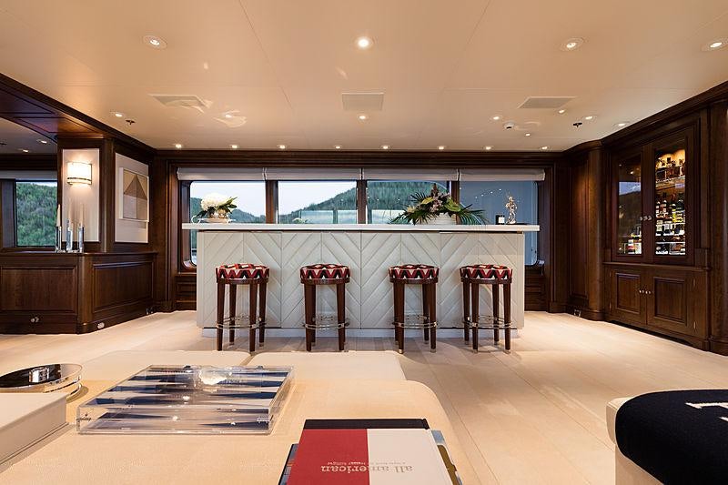 a large room with a table and chairs aboard FLAG Yacht for Charter