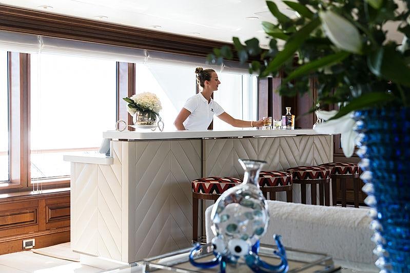 a person sitting on a couch aboard FLAG Yacht for Charter