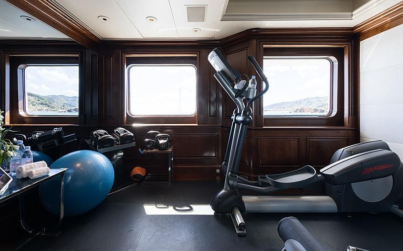 a room with a large window and a large blue exercise ball aboard FLAG Yacht for Charter
