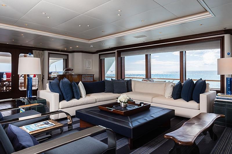 a living room with a large window aboard FLAG Yacht for Charter