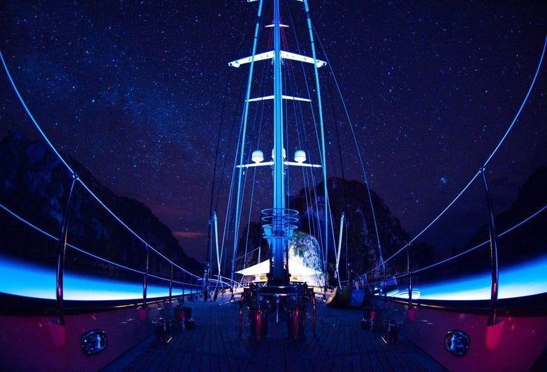 a large ship at night aboard ATHOS Yacht for Charter