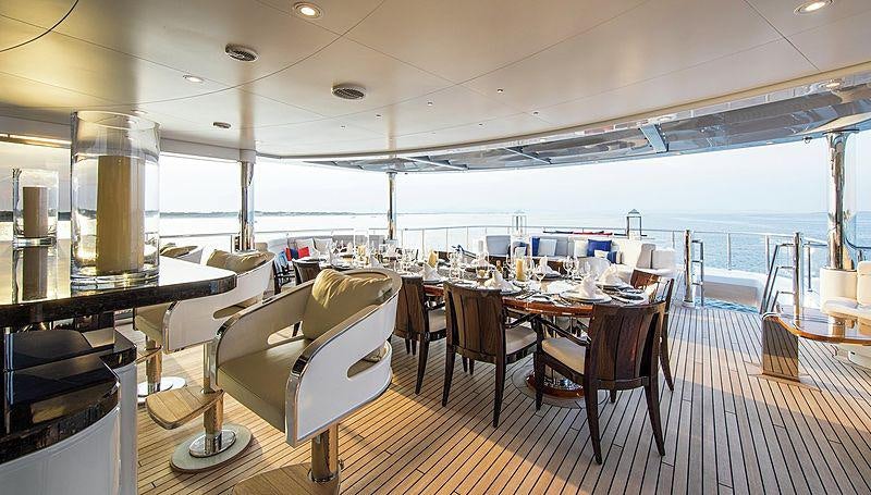 a room with a table chairs and a large window aboard ARIENCE Yacht for Charter