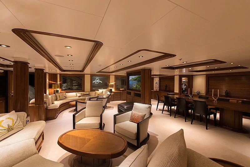 a large living room with a bar and a table aboard SEAWOLF Yacht for Charter