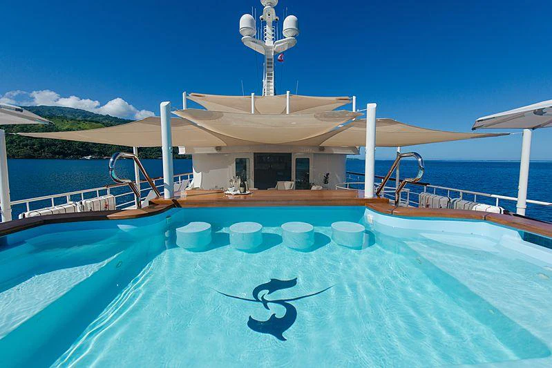 a swimming pool with a large building in the background aboard SEAWOLF Yacht for Charter