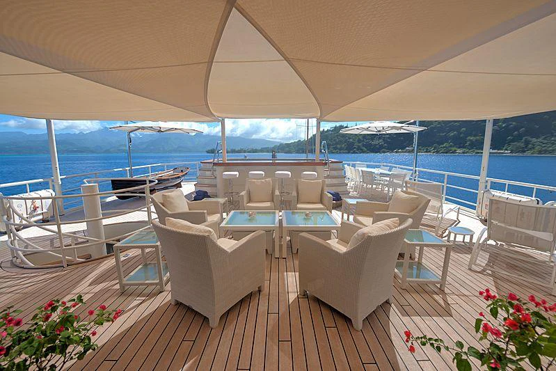 a room with a table chairs and a large body of water aboard SEAWOLF Yacht for Charter