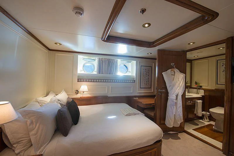 a hotel room with a bed and a large mirror aboard SEAWOLF Yacht for Charter