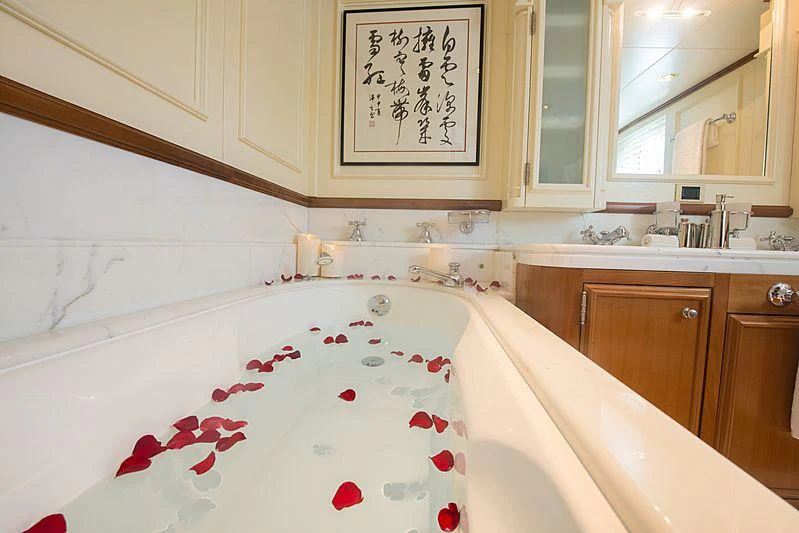 a bathroom with a bathtub sink and cabinets aboard SEAWOLF Yacht for Charter