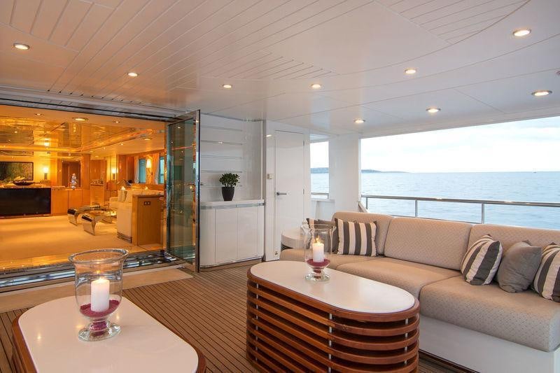 a living room with a large glass door and a table aboard O'NATALINA Yacht for Charter