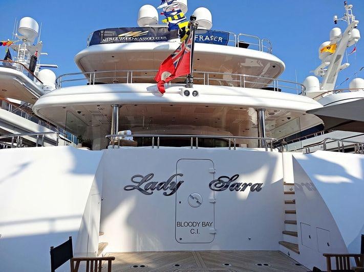 a large white boat with a red crane on it aboard LIBERTY Yacht for Charter