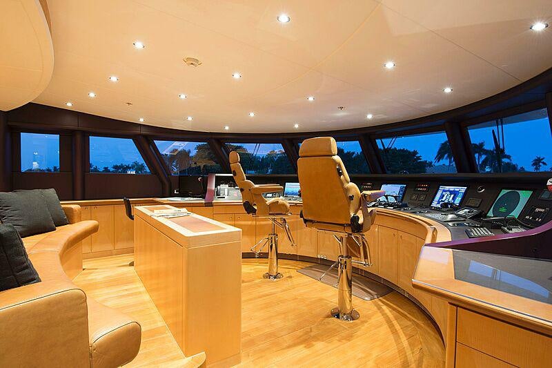 inside of a vehicle with a desk and chairs and a tv aboard SOUTH Yacht for Charter