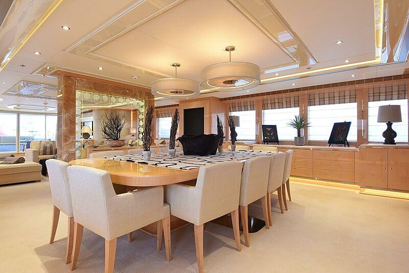 a large room with a table and chairs aboard SOUTH Yacht for Charter