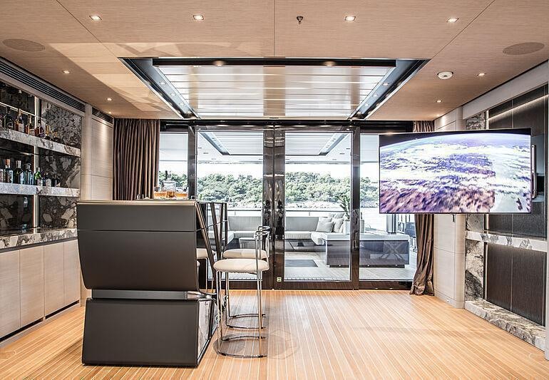 a room with a large window and a large table with chairs aboard SEVERIN*S Yacht for Charter