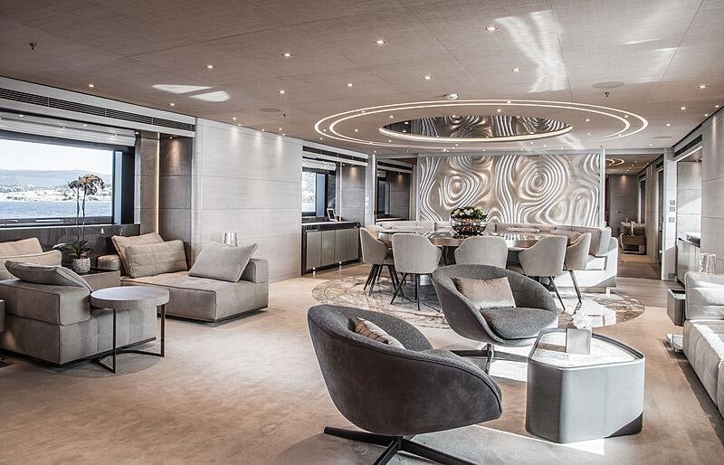 a room with a large chandelier and a couch aboard SEVERIN*S Yacht for Charter