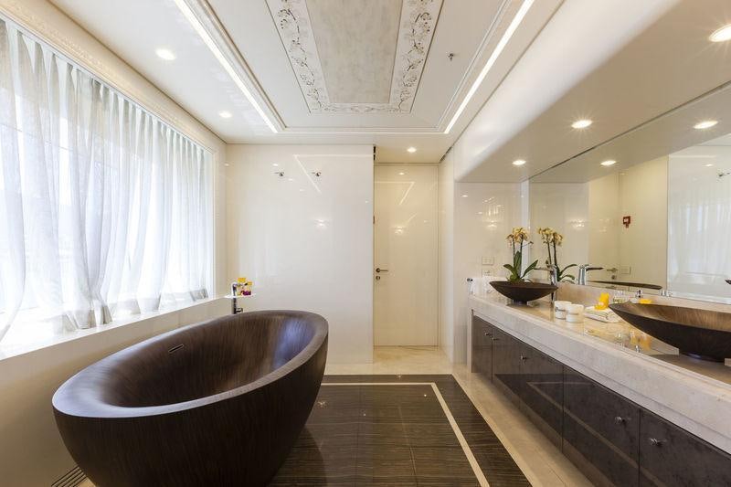 a bathroom with a tub sink and a large bathtub aboard QUINTA ESSENTIA Yacht for Charter