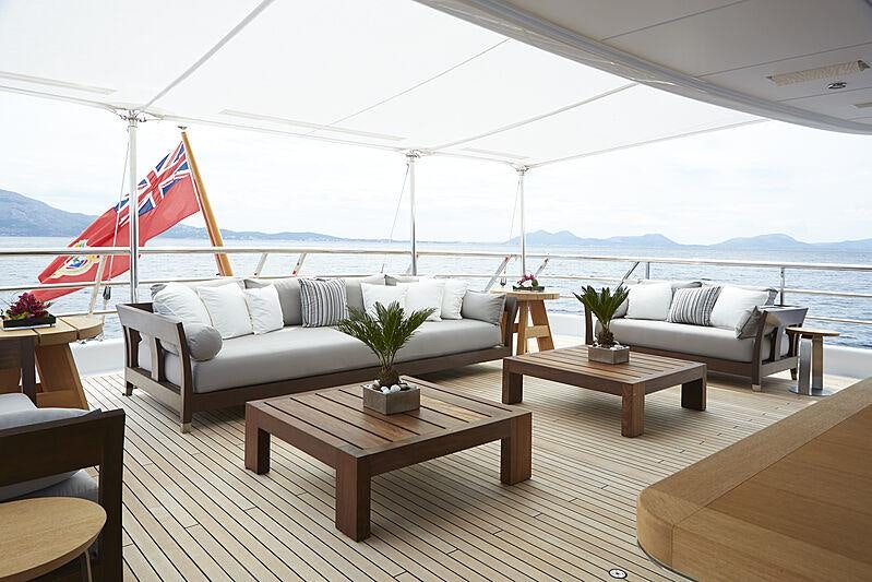 a living room with a large flag aboard SPIRIT Yacht for Charter