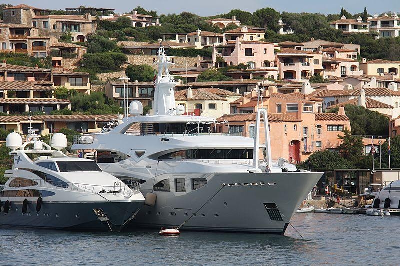 a couple of boats in a harbor aboard MARAYA Yacht for Charter