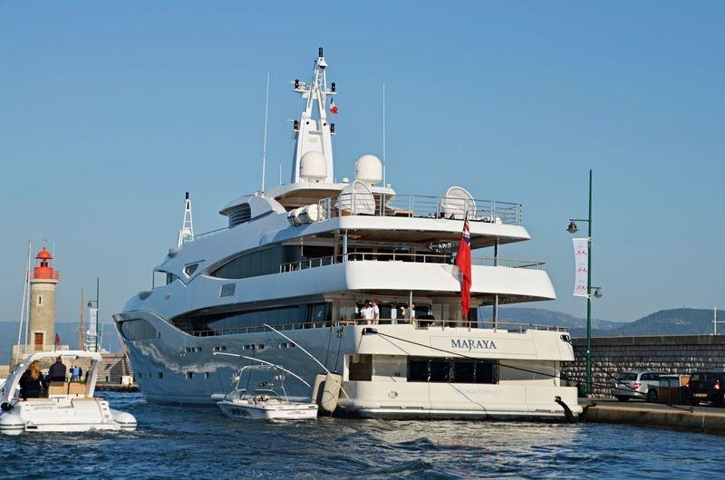 a large white boat with a lighthouse on the water aboard MARAYA Yacht for Charter
