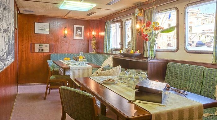 a room with a table and chairs aboard SANSSOUCI STAR Yacht for Charter