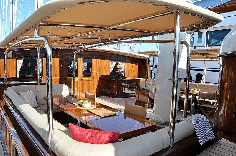a room with a bed and a table aboard MIKHAIL S. VORONTSOV Yacht for Charter