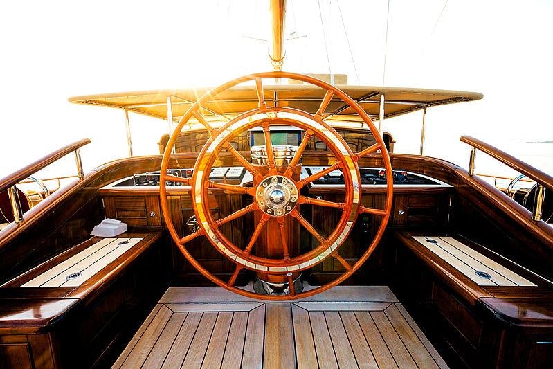 a wooden steering wheel on a boat aboard MIKHAIL S. VORONTSOV Yacht for Charter