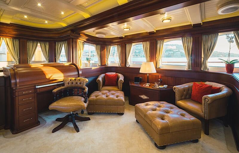 a living room with a couch and a coffee table aboard MIKHAIL S. VORONTSOV Yacht for Charter