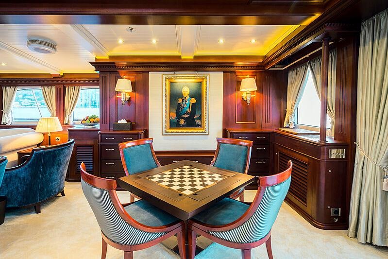 a room with a table chairs and a couch aboard MIKHAIL S. VORONTSOV Yacht for Charter