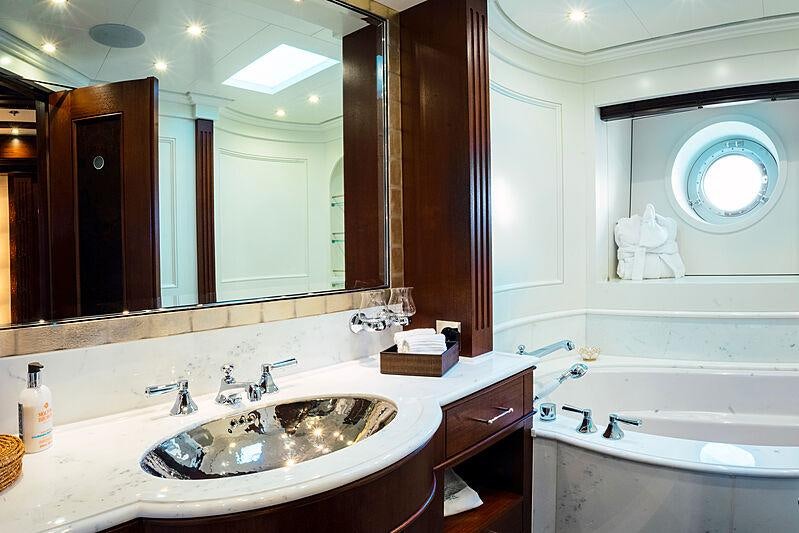 a bathroom with a sink and bathtub aboard MIKHAIL S. VORONTSOV Yacht for Charter