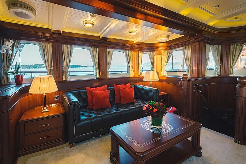 a large living room with a large bed and a large window aboard MIKHAIL S. VORONTSOV Yacht for Charter