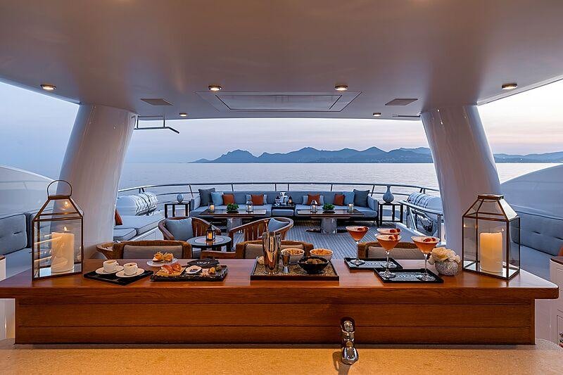 a large room with a table and chairs aboard LIND Yacht for Charter
