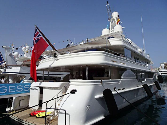 a large white boat with flags on it aboard DEJA TOO Yacht for Charter