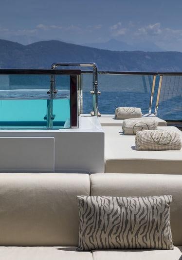 a room with a couch and a pool aboard SEVEN SINS Yacht for Charter