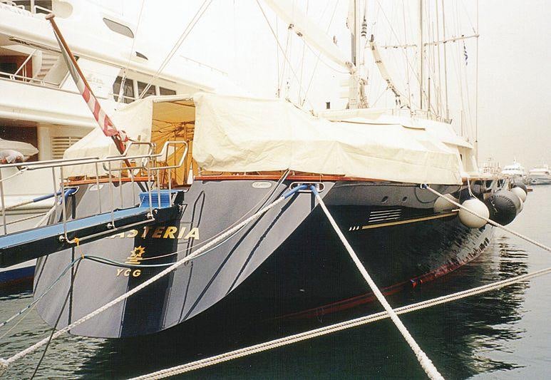 a boat with a white sail aboard XASTERIA Yacht for Charter