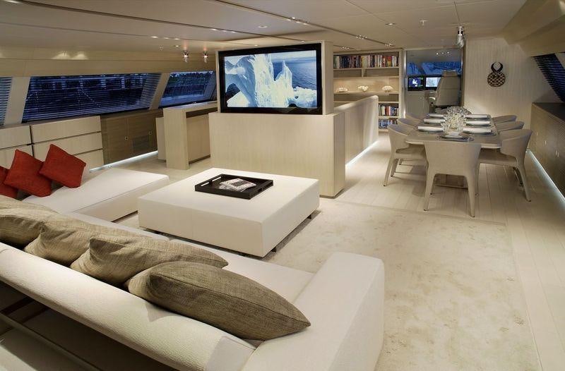 a room with a couch and a tv aboard RED DRAGON Yacht for Charter