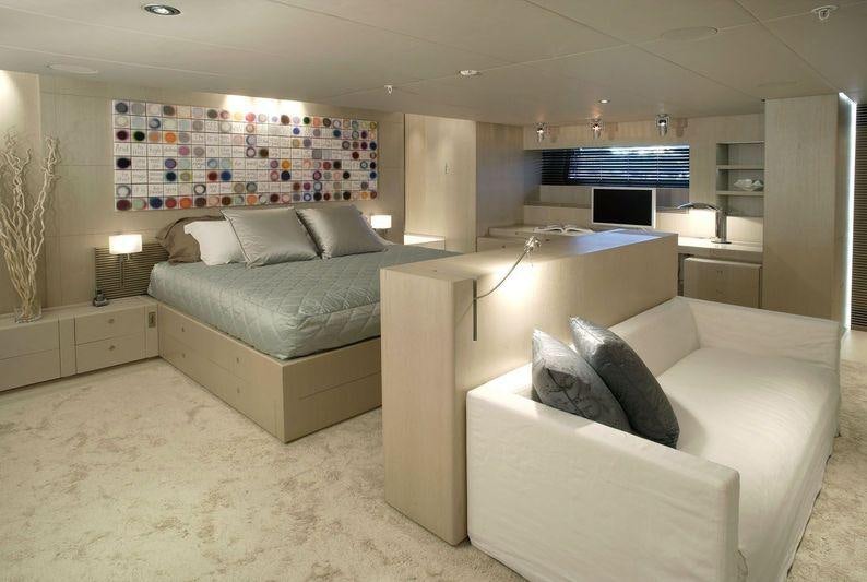 a living room with a couch and a tv aboard RED DRAGON Yacht for Charter