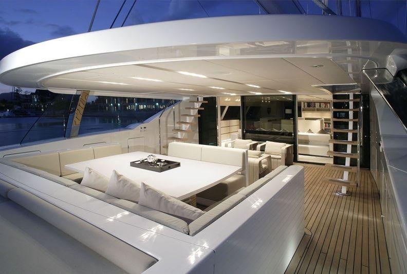 a room with a large white couch aboard RED DRAGON Yacht for Charter