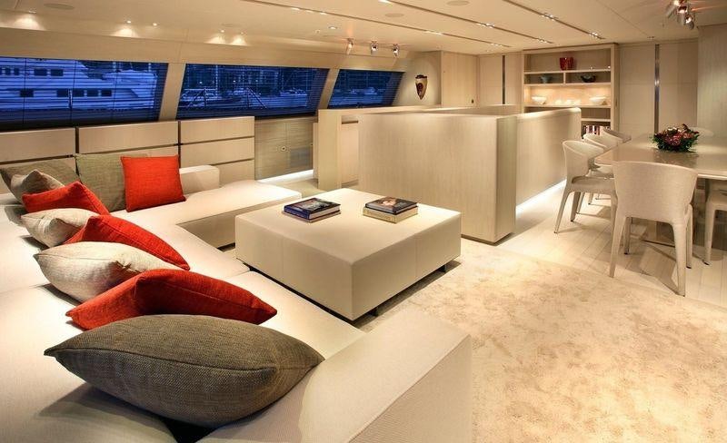 a large room with a couch and a table aboard RED DRAGON Yacht for Charter
