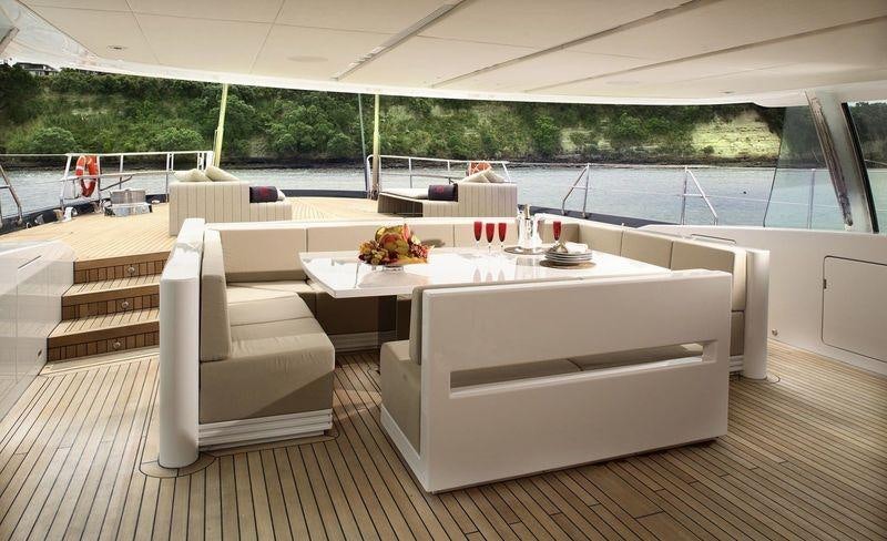 a room with a table and chairs aboard RED DRAGON Yacht for Charter