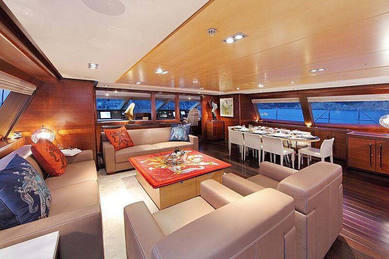 a living room with a large window aboard PRANA Yacht for Charter
