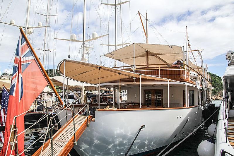 a boat with a flag on the front aboard MALAHNE Yacht for Charter