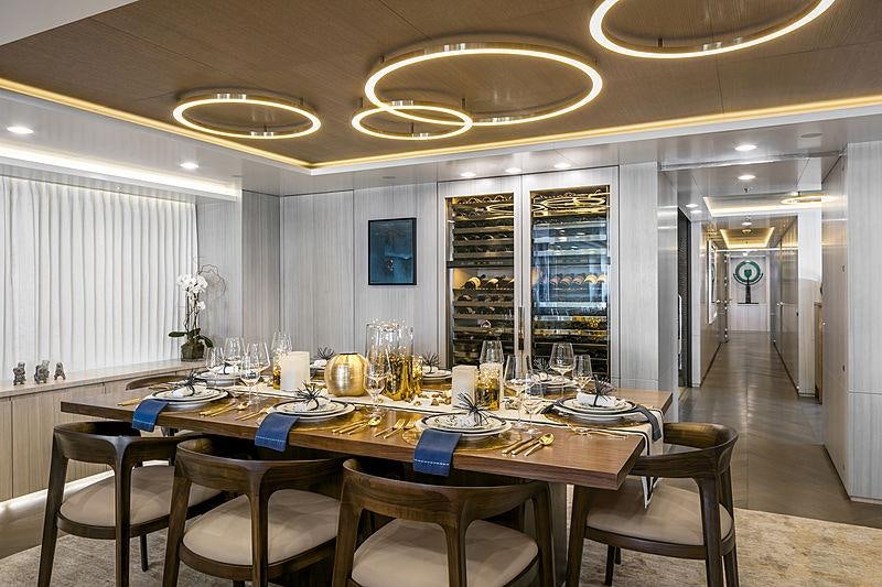 a dining room with a table set aboard REVERIE Yacht for Charter