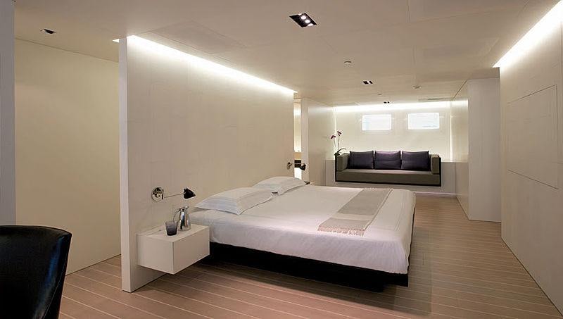 a room with a bed and a couch aboard BARACUDA VALLETTA Yacht for Charter