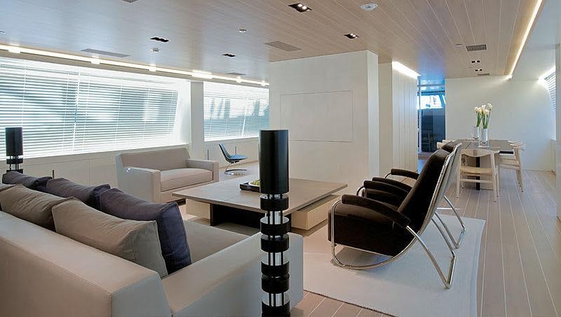 a room with a table and a tv aboard BARACUDA VALLETTA Yacht for Charter