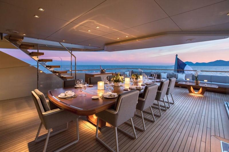 a table set for a dinner party aboard VERTIGE Yacht for Charter