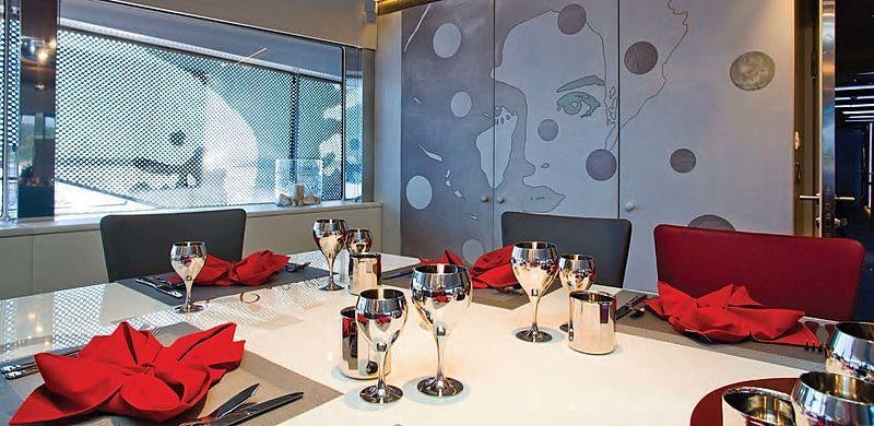 a table with wine glasses and napkins on it aboard JOY ME Yacht for Charter