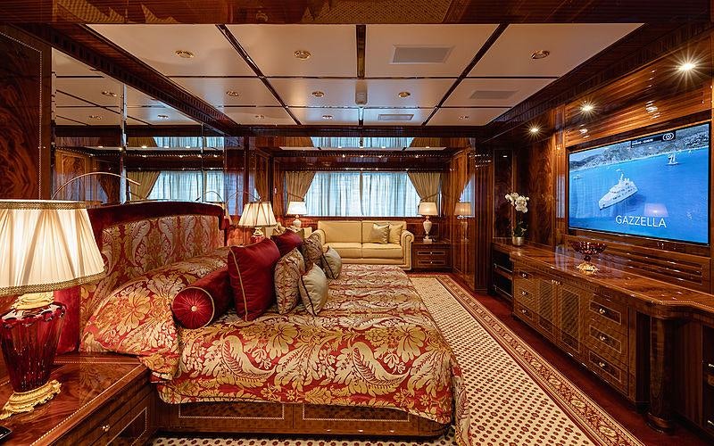 a large living room with a large screen aboard KADIMO'S Yacht for Charter